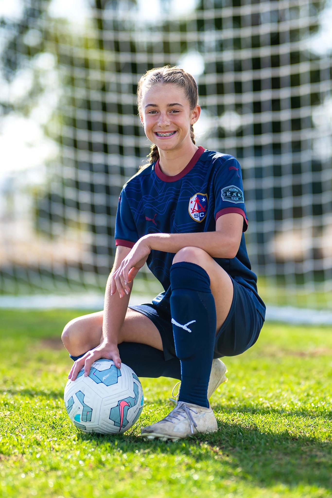 Alameda Soccer Club female soccer player portrait during golden hour in front of a goal