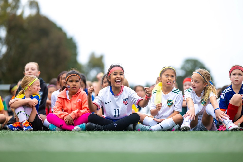 Young female soccer players during a chat at an all girls soccer camp